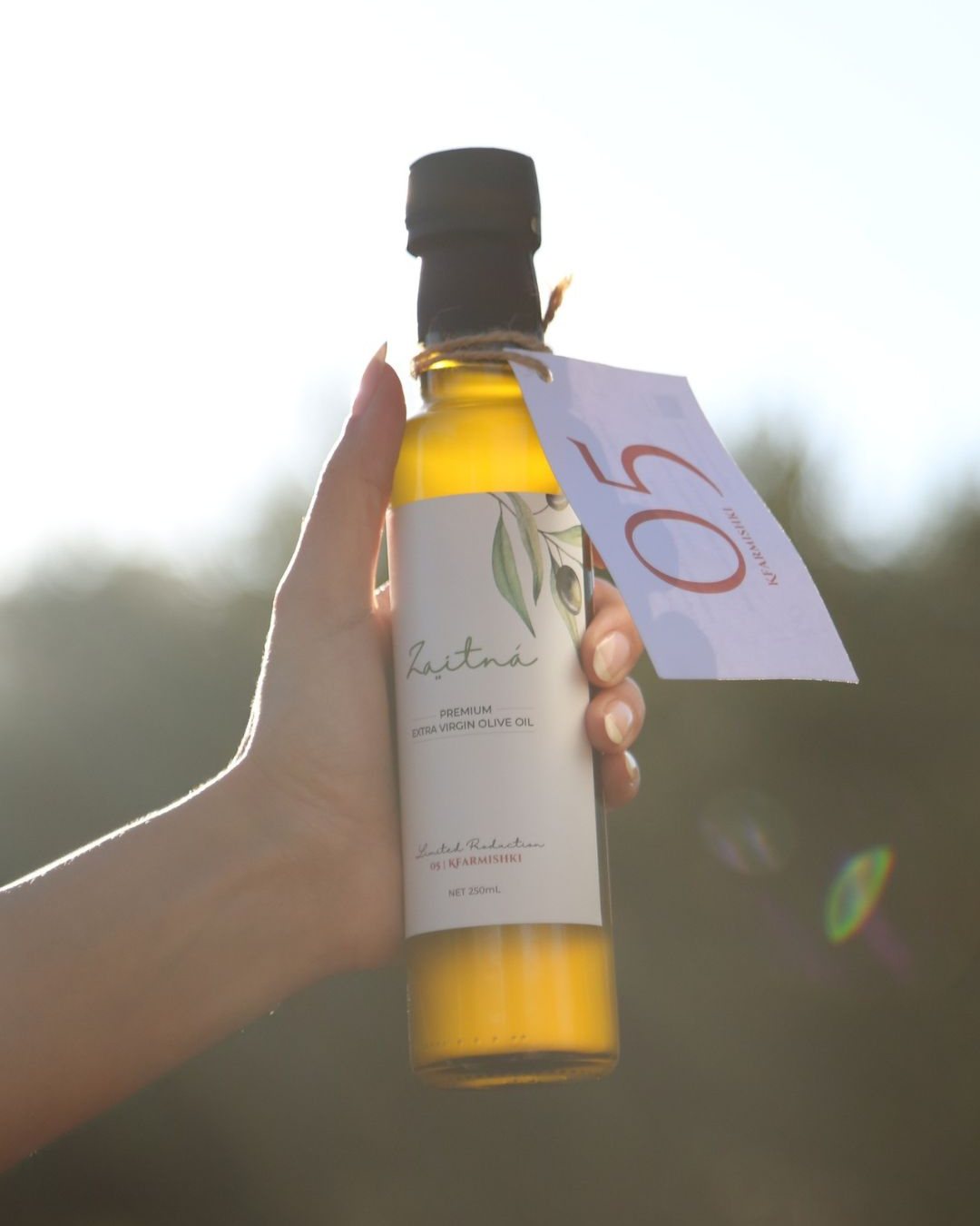 A bottle of Zaitná 05 Kfarmishki held up against the sky
